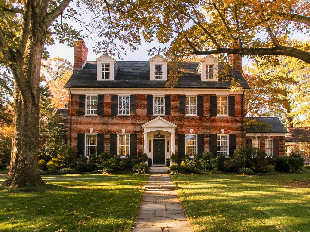 A Pennsylvania brick colonial home framed by mature trees